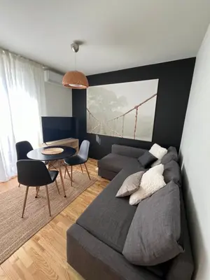 a bedroom with a bed and a table and a couch at Apartament Sołtysowska- garaż bezpłatny, NEAR Tauron Arena, EXPO in Kraków