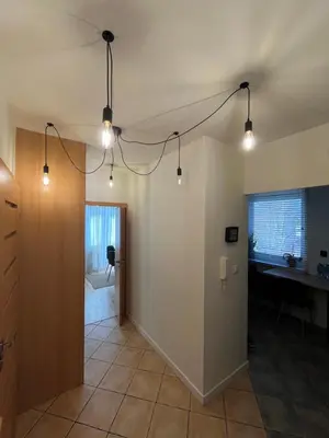 a kitchen with a window with blinds and a wooden table at Apartament Sołtysowska- garaż bezpłatny, NEAR Tauron Arena, EXPO in Kraków