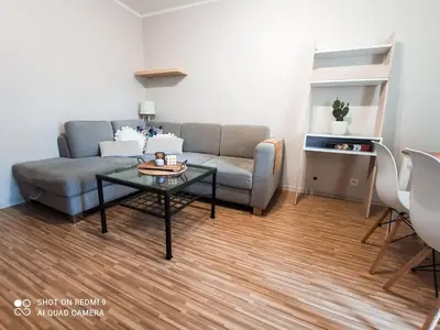 a living room with a couch and a table at Apartament boBoski in Wadowice