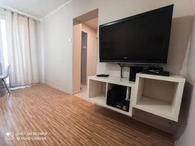 a living room with a flat screen tv on a entertainment center at Apartament boBoski in Wadowice
