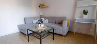 a living room with a couch and a table at Apartament boBoski in Wadowice
