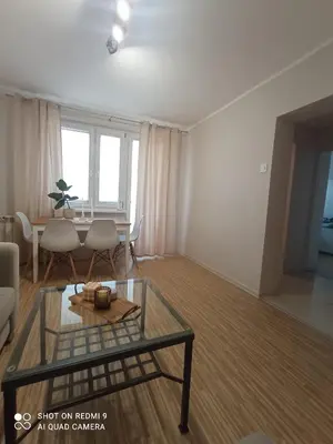 a living room with a table and a dining room at Apartament boBoski in Wadowice