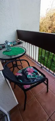 a table and a chair on a balcony at Apartament boBoski in Wadowice