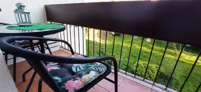 a chair sitting on a balcony next to a table at Apartament boBoski in Wadowice