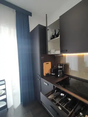a kitchen with a stove top oven next to a window at Near Sanktuarium Beautiful View and Free Parking in Kraków