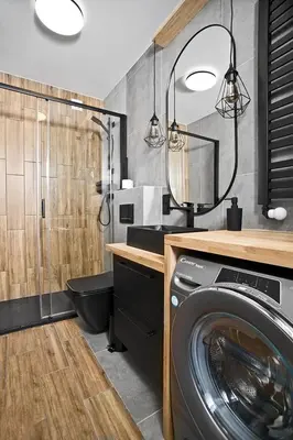 a bathroom with a washing machine and a mirror at Near Sanktuarium Beautiful View and Free Parking in Kraków