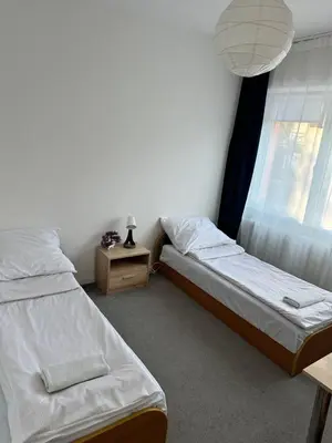 two beds in a room with a window at Hostel Demi in Kraków