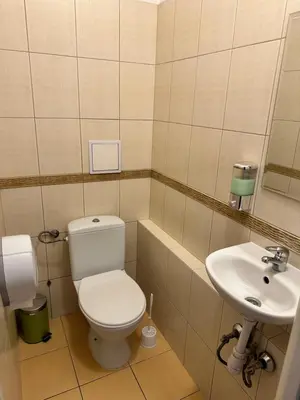 a bathroom with a toilet and a sink at Hostel Demi in Kraków