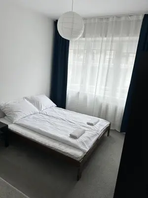 a bed in a room with a window at Hostel Demi in Kraków