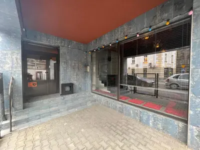 a room with two large windows with a view of a street at Hostel Demi in Kraków