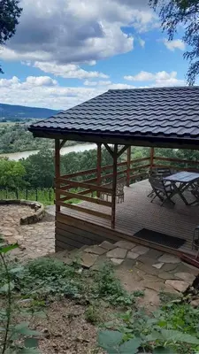a wooden gazebo with a table and a bench at Domki Na Winnicy - Winnica Talaska in Melsztyn