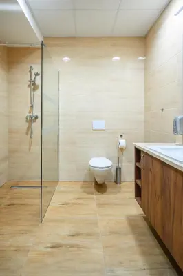 a bathroom with a toilet and a glass shower at Pokoje Gościnne MODR in Karniowice