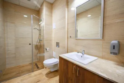 a bathroom with a toilet and a sink and a shower at Pokoje Gościnne MODR in Karniowice