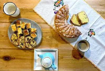 a table with a plate of bread and a plate of coffee at MATOGÓWKA in Krzeszowice