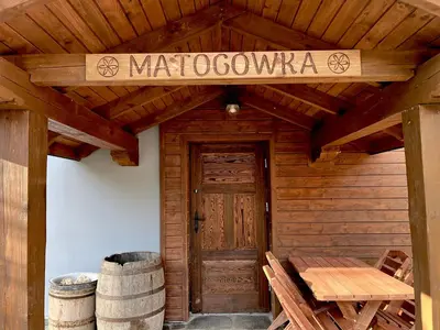 a wooden cabin with a wooden door and a sign that reads matosovarma at MATOGÓWKA in Krzeszowice