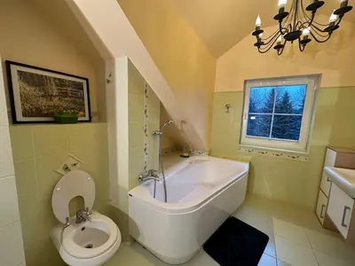a bathroom with a tub and a toilet and a sink at Rezydencja Pod Platanem in Smardzowice
