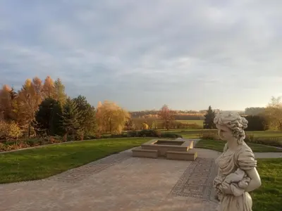 a statue of a girl standing in a park at Rezydencja Pod Platanem in Smardzowice