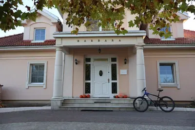 a bike parked in front of a pink house at Rezydencja Pod Platanem in Smardzowice