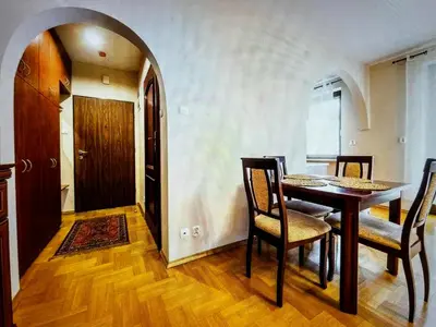 a dining room with a table and chairs and a door at Krupnicza Apartment in Kraków