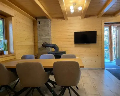 a conference room with a table and chairs and a television at Domek Nad Stawem II in Limanowa