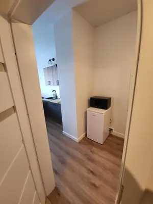 an empty room with a kitchen and a mirror at Nest Niebieski in Zator