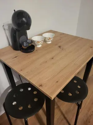 a wooden table with two chairs and bowls on it at Nest Niebieski in Zator
