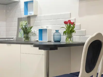 a kitchen counter with vases and flowers on it at Solne Apartamenty Luna in Wieliczka
