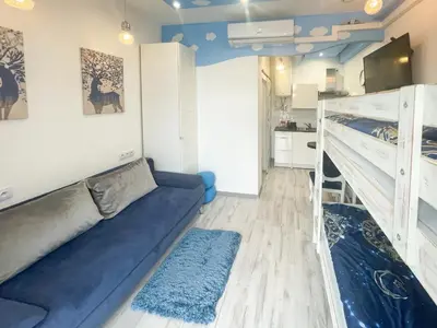 a living room with a couch and bunk beds at Solne Apartamenty Luna in Wieliczka