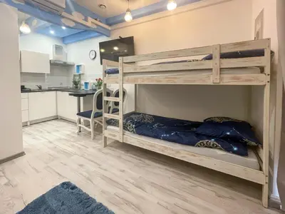 two bunk beds in a room with a kitchen at Solne Apartamenty Luna in Wieliczka