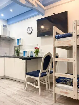 a loft bed room with a desk and bunk beds at Solne Apartamenty Luna in Wieliczka
