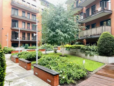 a park with a bench in front of a building at Angel MINT Apartment - FREE PARKING - Balcony in Kraków