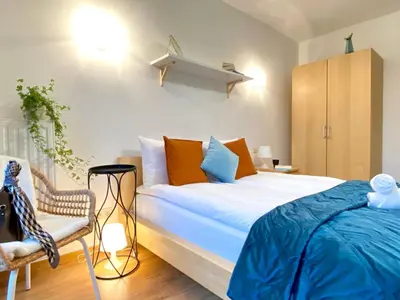 a bedroom with a large bed and a chair at Angel MINT Apartment - FREE PARKING - Balcony in Kraków