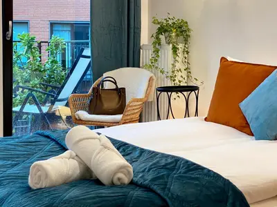 a bedroom with a bed with a towel on it at Angel MINT Apartment - FREE PARKING - Balcony in Kraków