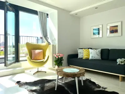 a living room with a couch and a chair at Angel MINT Apartment - FREE PARKING - Balcony in Kraków