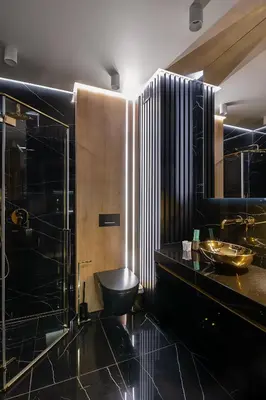 a bathroom with a black sink and a toilet at Wiślane Tarasy VIP Apartamenty JACUZZI in Kraków