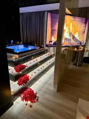 a room with a hot tub and a fireplace at Wiślane Tarasy VIP Apartamenty JACUZZI in Kraków