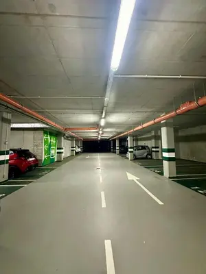 an empty parking garage with cars parked in it at Wiślane Tarasy VIP Apartamenty JACUZZI in Kraków