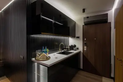 a kitchen with a sink and a counter top at Wiślane Tarasy VIP Apartamenty JACUZZI in Kraków