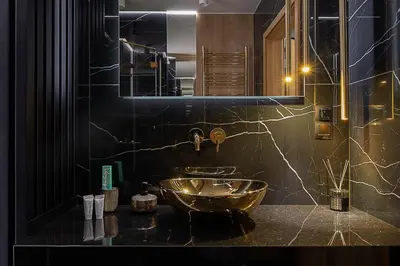 a bathroom with a sink and a large mirror at Wiślane Tarasy VIP Apartamenty JACUZZI in Kraków