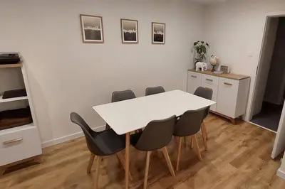 a dining room with a white table and chairs at Przytulne mieszkanie w Olkuszu/ Cosy apartment in Olkusz in Olkusz