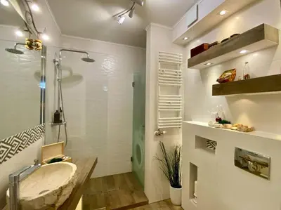 a white walk in closet with lots of clothes at White and Bright Riverside View Flat with Parking, Bike Access, and Onsite Gym in Kraków