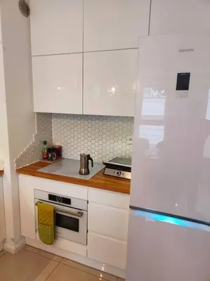 a bathroom with a sink and a glass shower at White and Bright Riverside View Flat with Parking, Bike Access, and Onsite Gym in Kraków