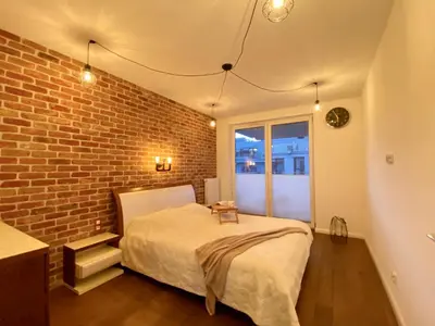 a balcony with a view of a building at White and Bright Riverside View Flat with Parking, Bike Access, and Onsite Gym in Kraków