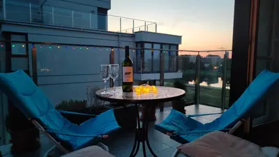 a bedroom with a bed and a brick wall at White and Bright Riverside View Flat with Parking, Bike Access, and Onsite Gym in Kraków