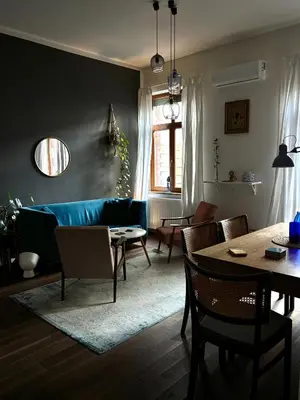 a living room with a blue couch and a table at D7 Apartment in Kraków