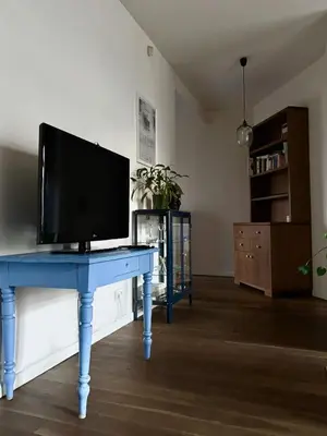 a blue desk with a television on top of it at D7 Apartment in Kraków