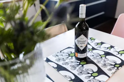 a bottle of wine sitting on a table at Modern House in Old Town Numero 5 in Kraków