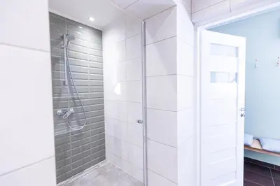 a shower with a glass door in a bathroom at Modern House in Old Town Numero 5 in Kraków