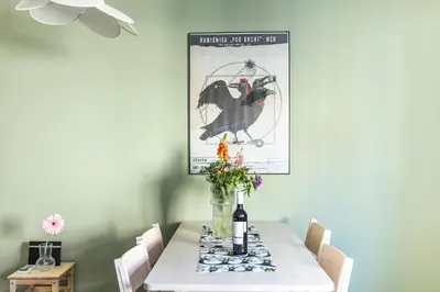 a dining room table with a vase of flowers on it at Modern House in Old Town Numero 5 in Kraków