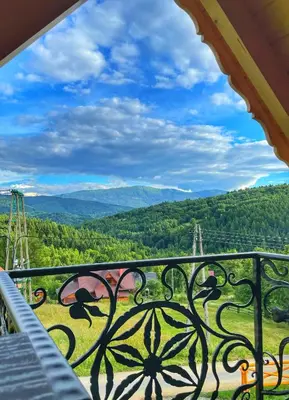 a view from a balcony with a view of the mountains at Gliniana Chata in Zawoja